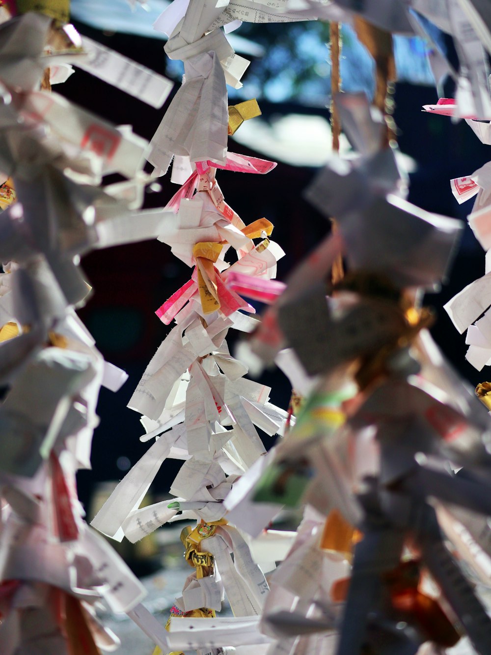 a bunch of paper cranes hanging from a ceiling