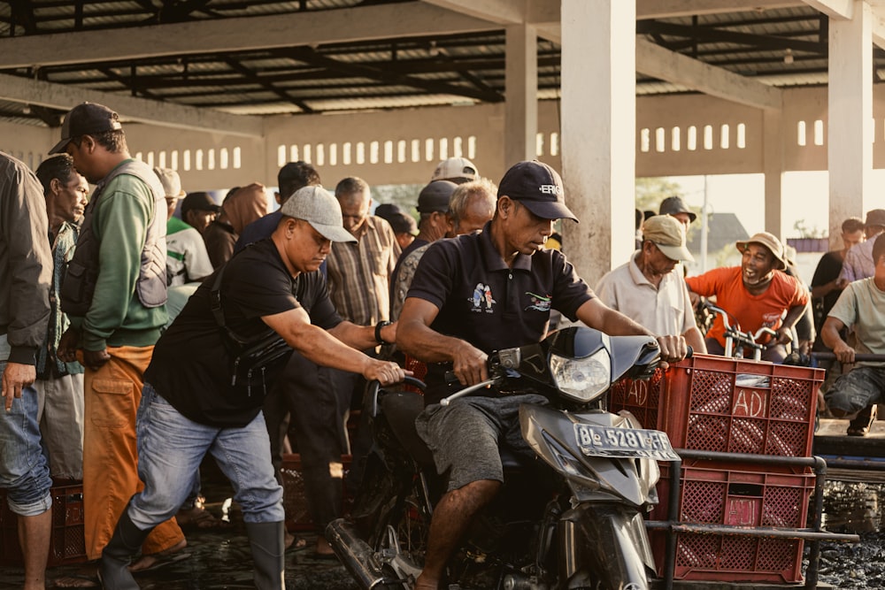 a group of people standing around a motorcycle