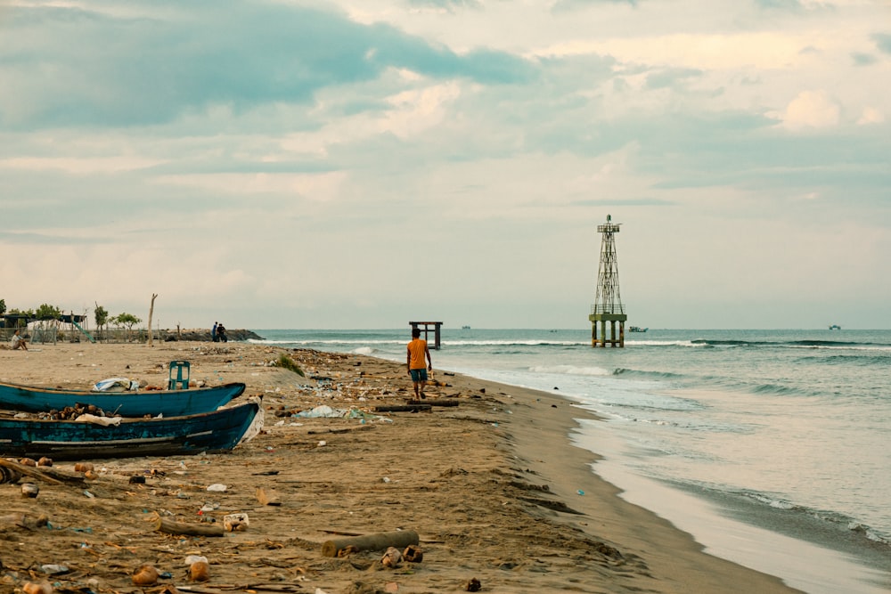 two boats sitting on top of a sandy beach