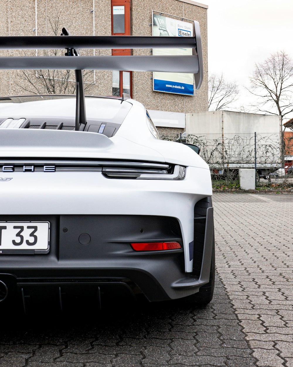 a white sports car parked in front of a building