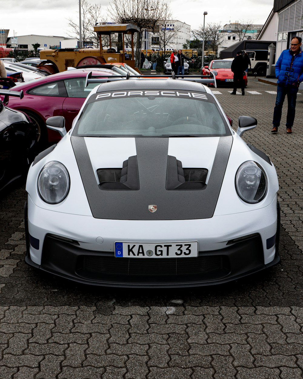 a white sports car parked in a parking lot