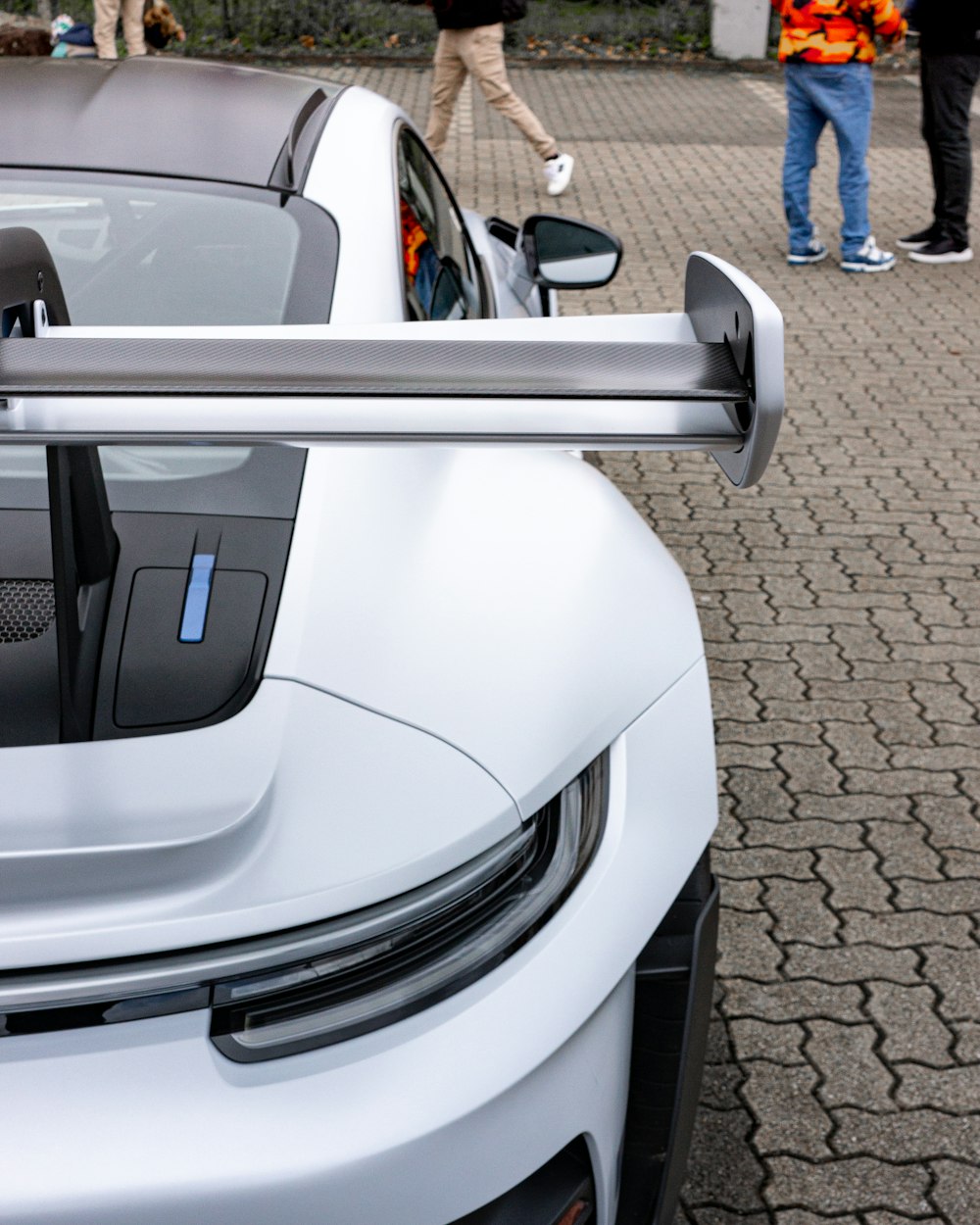 a white sports car parked on the side of a road