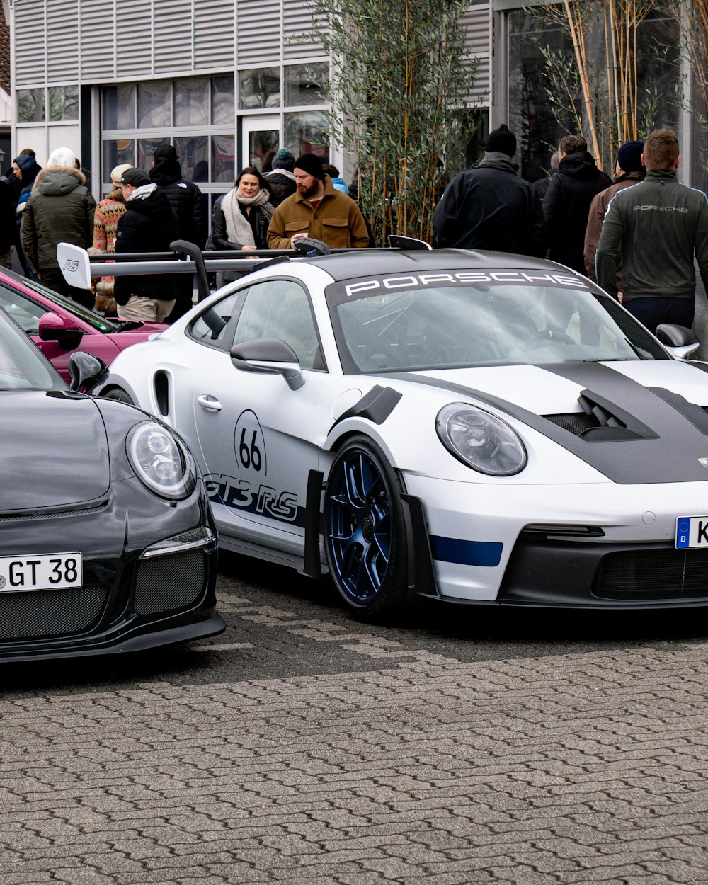 a couple of cars parked next to each other on a street