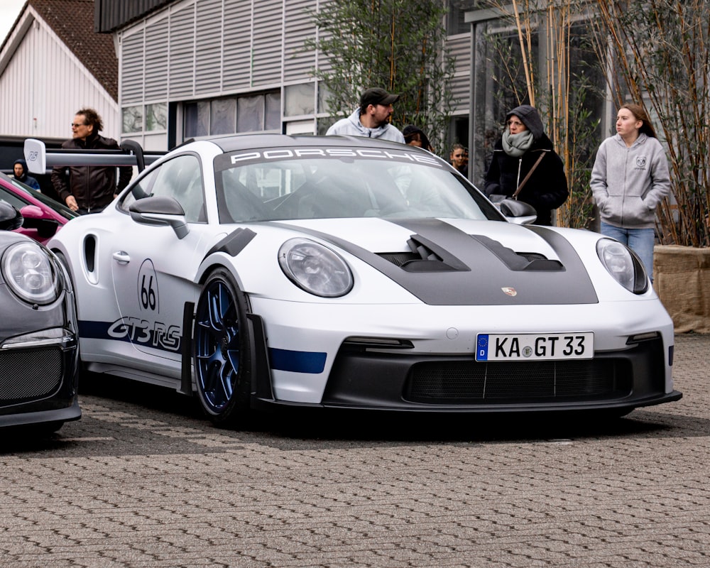 two porsches parked next to each other on a street