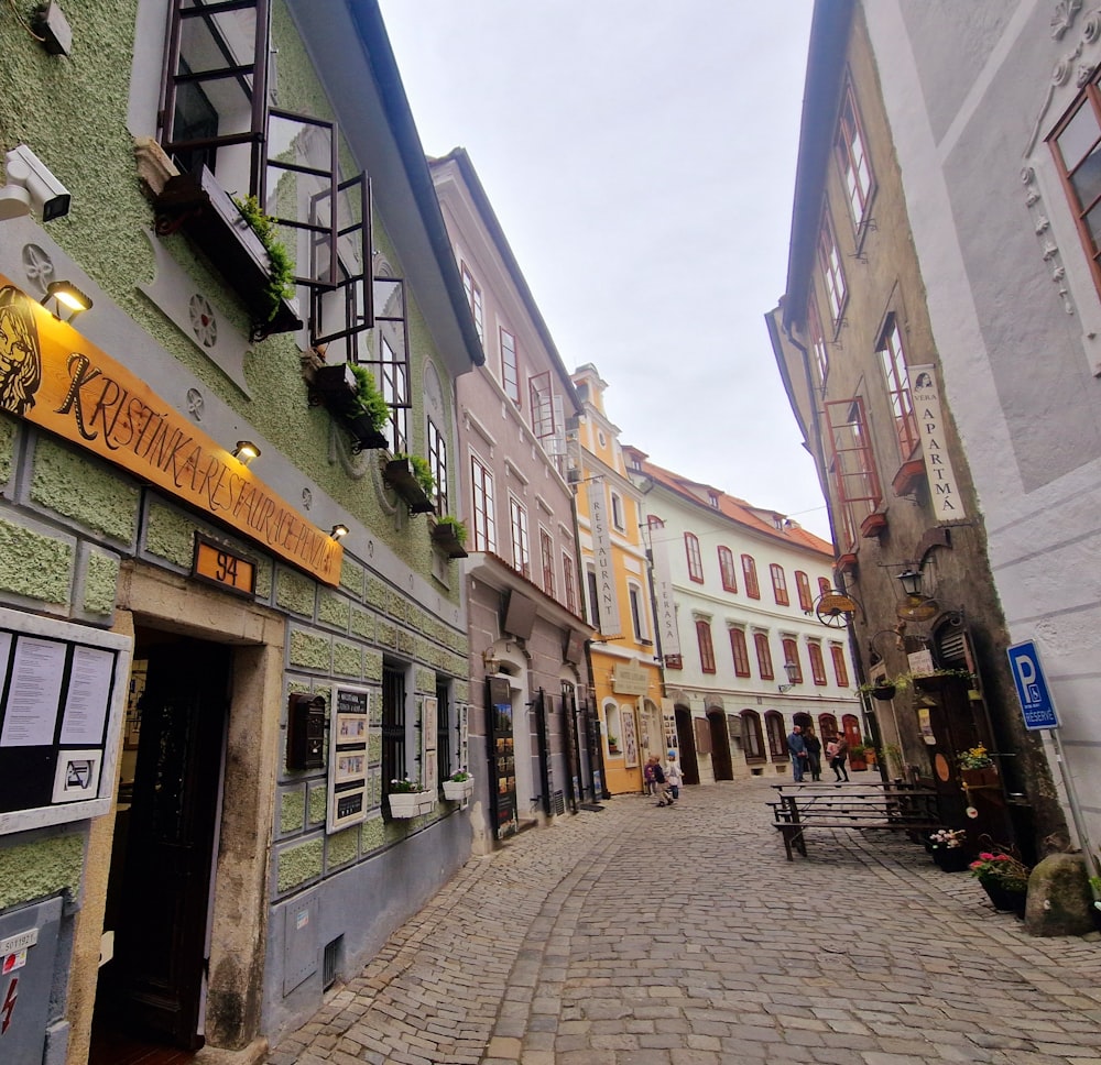 a cobblestone street lined with tall buildings