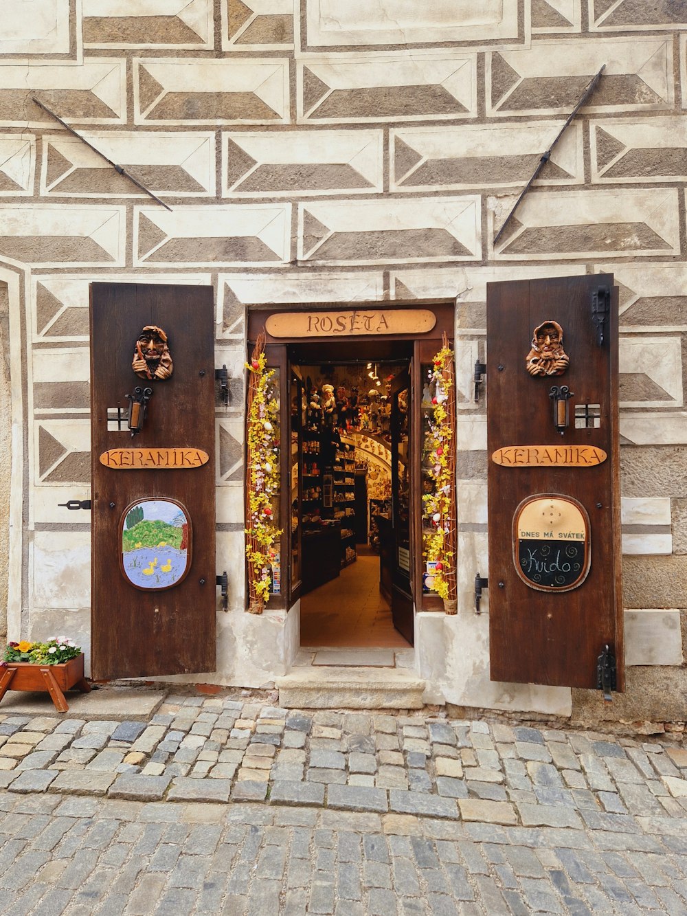 a store front with wooden doors and decorative decorations