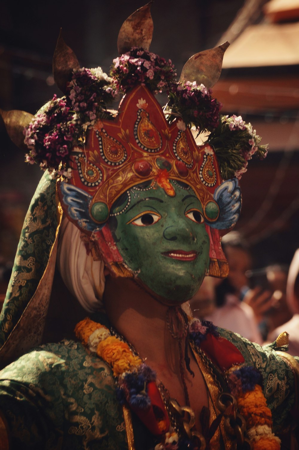 a woman with a green face and head dress