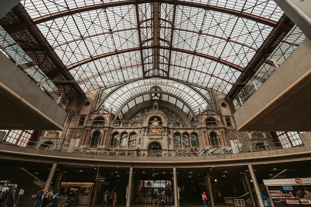 the inside of a train station with a glass ceiling