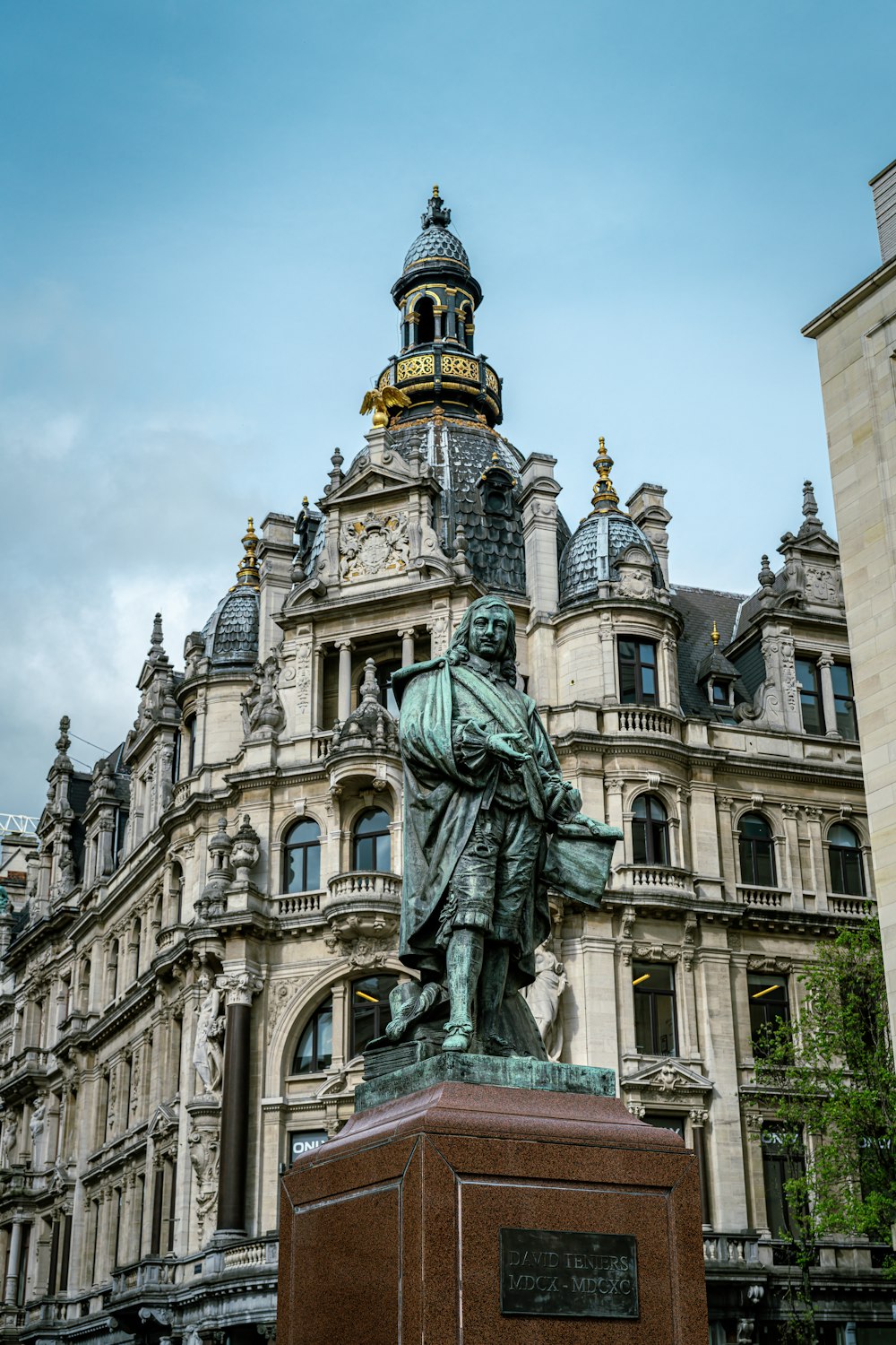 a statue of a man in front of a building