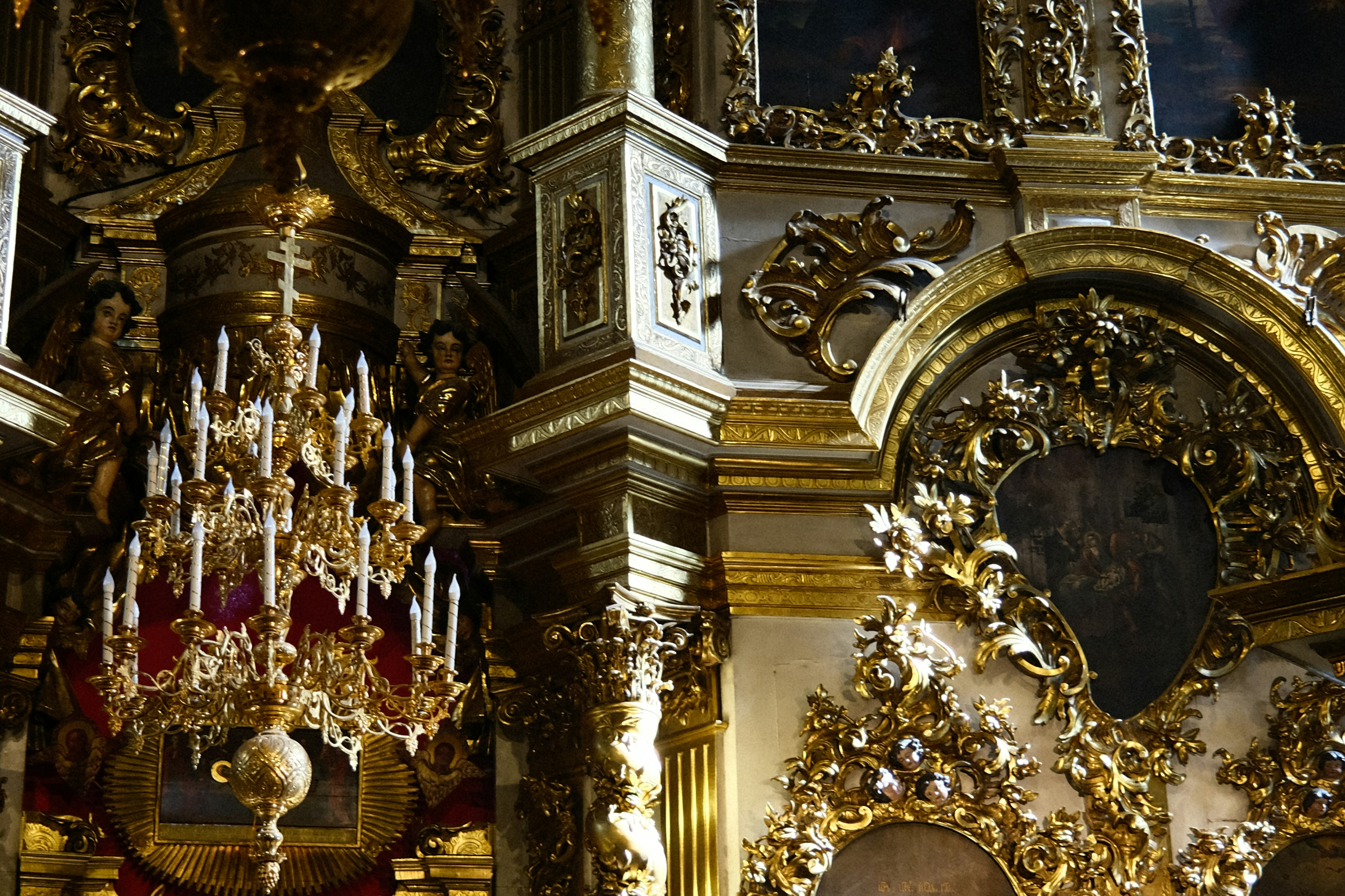 a gold and white church with a chandelier