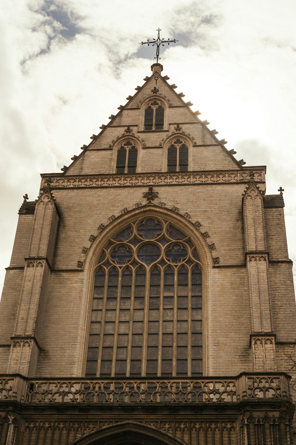 a tall building with a cross on top of it