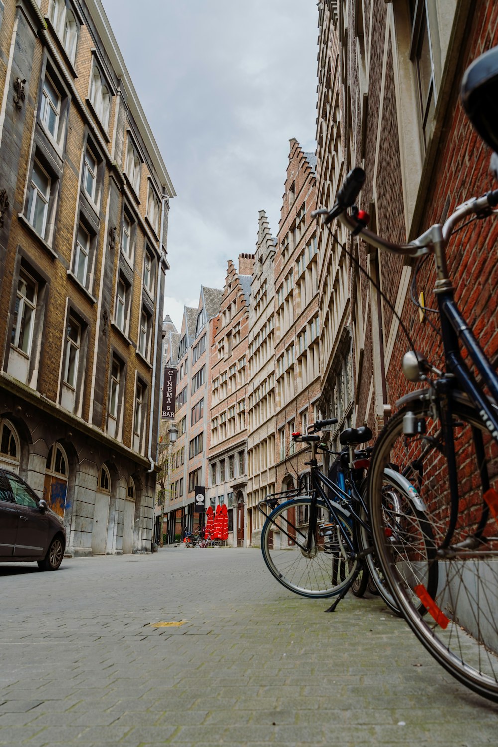 a couple of bikes parked next to a building