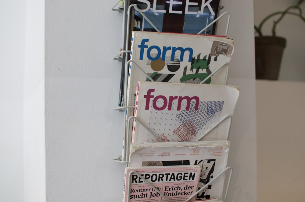 a bunch of newspapers that are hanging on a wall