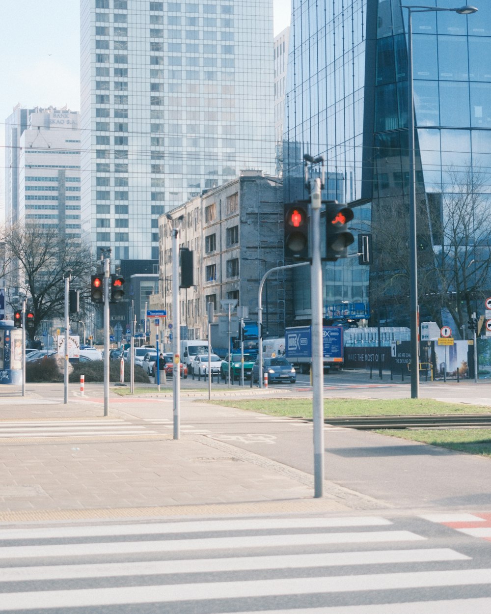 a traffic light on a city street with tall buildings in the background