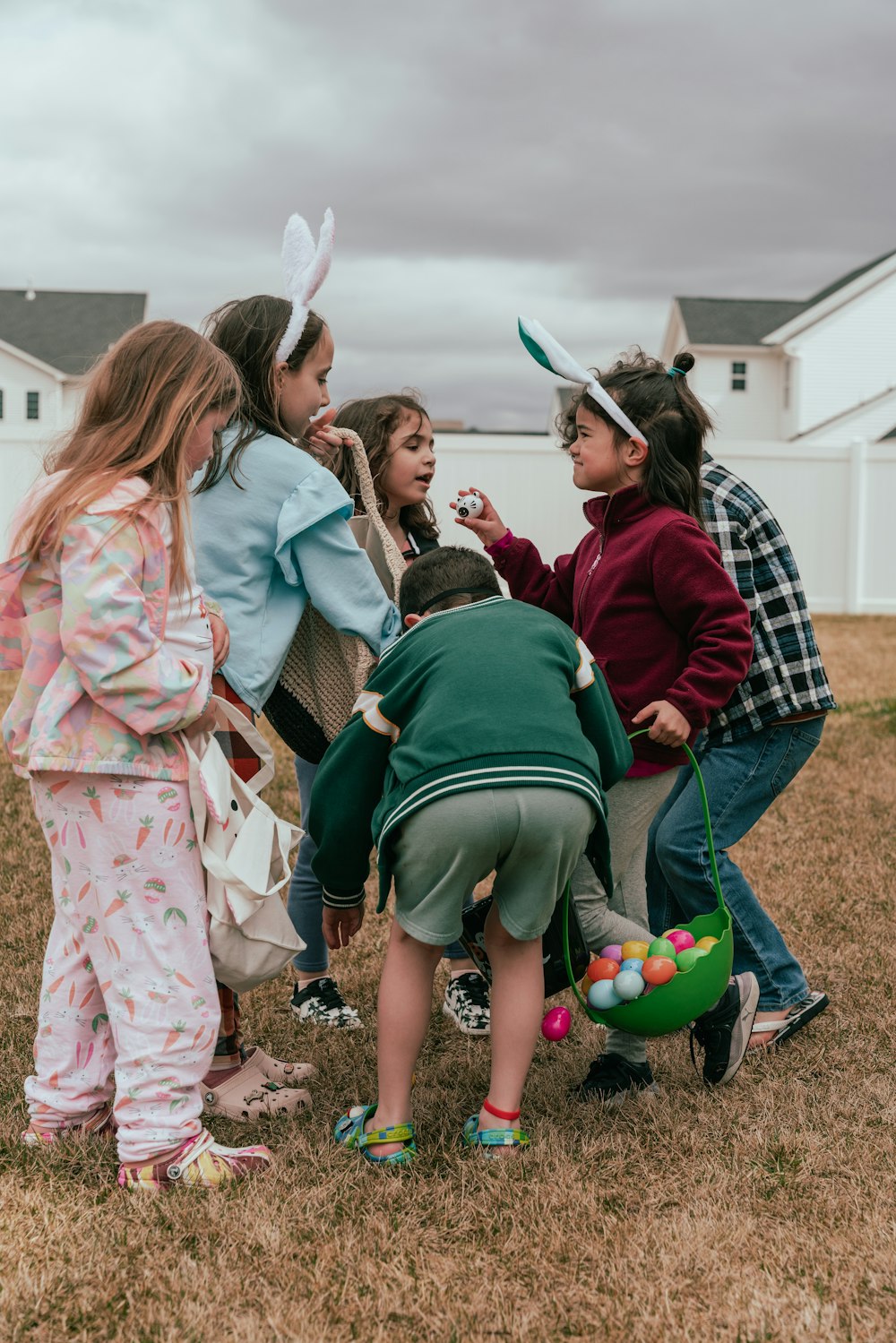 a group of young children standing around each other