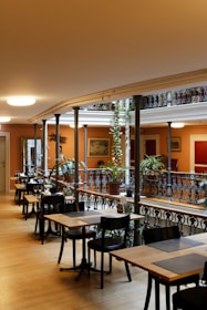 a restaurant with tables and chairs and a balcony