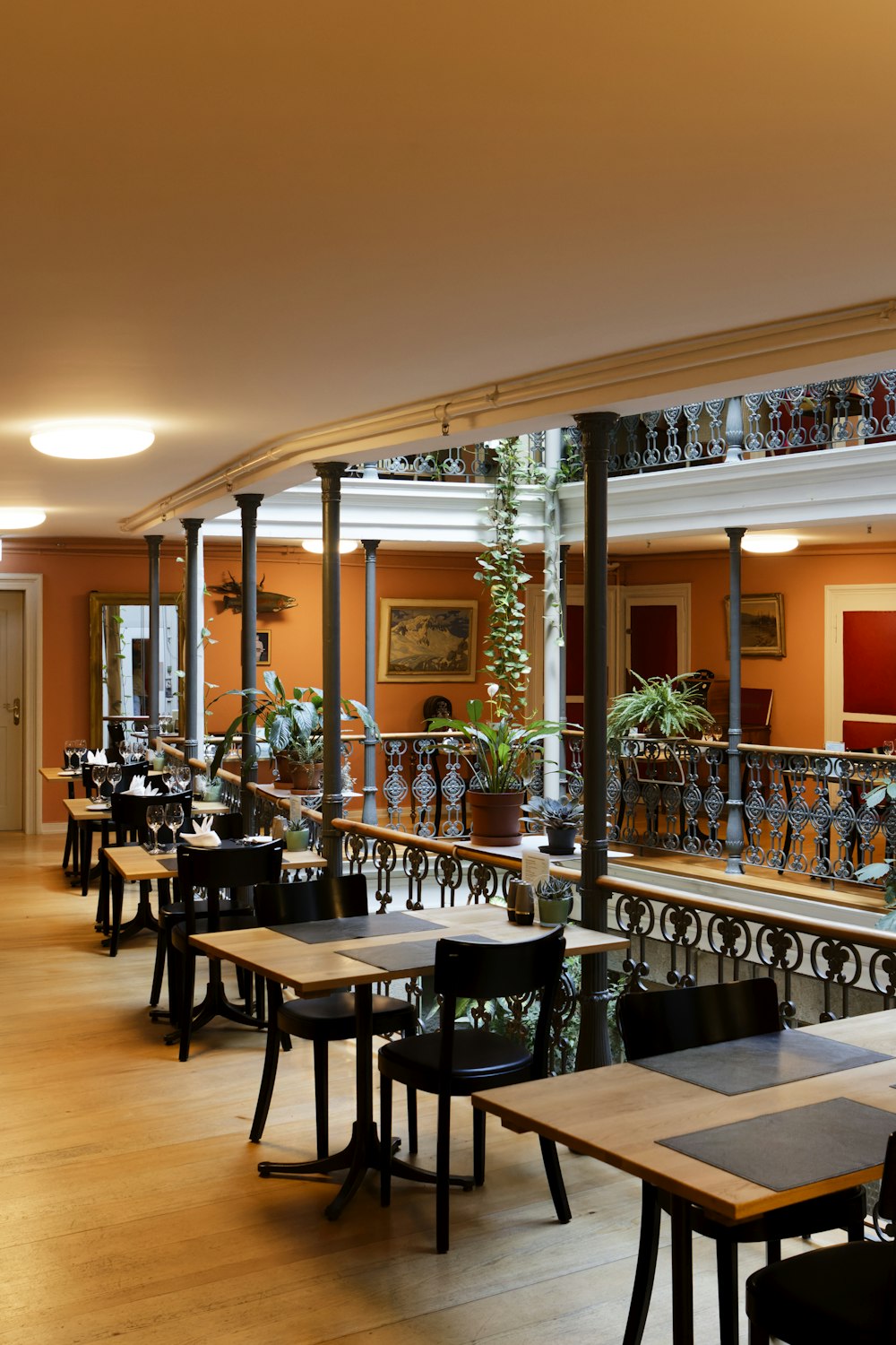 a restaurant with tables and chairs and a balcony