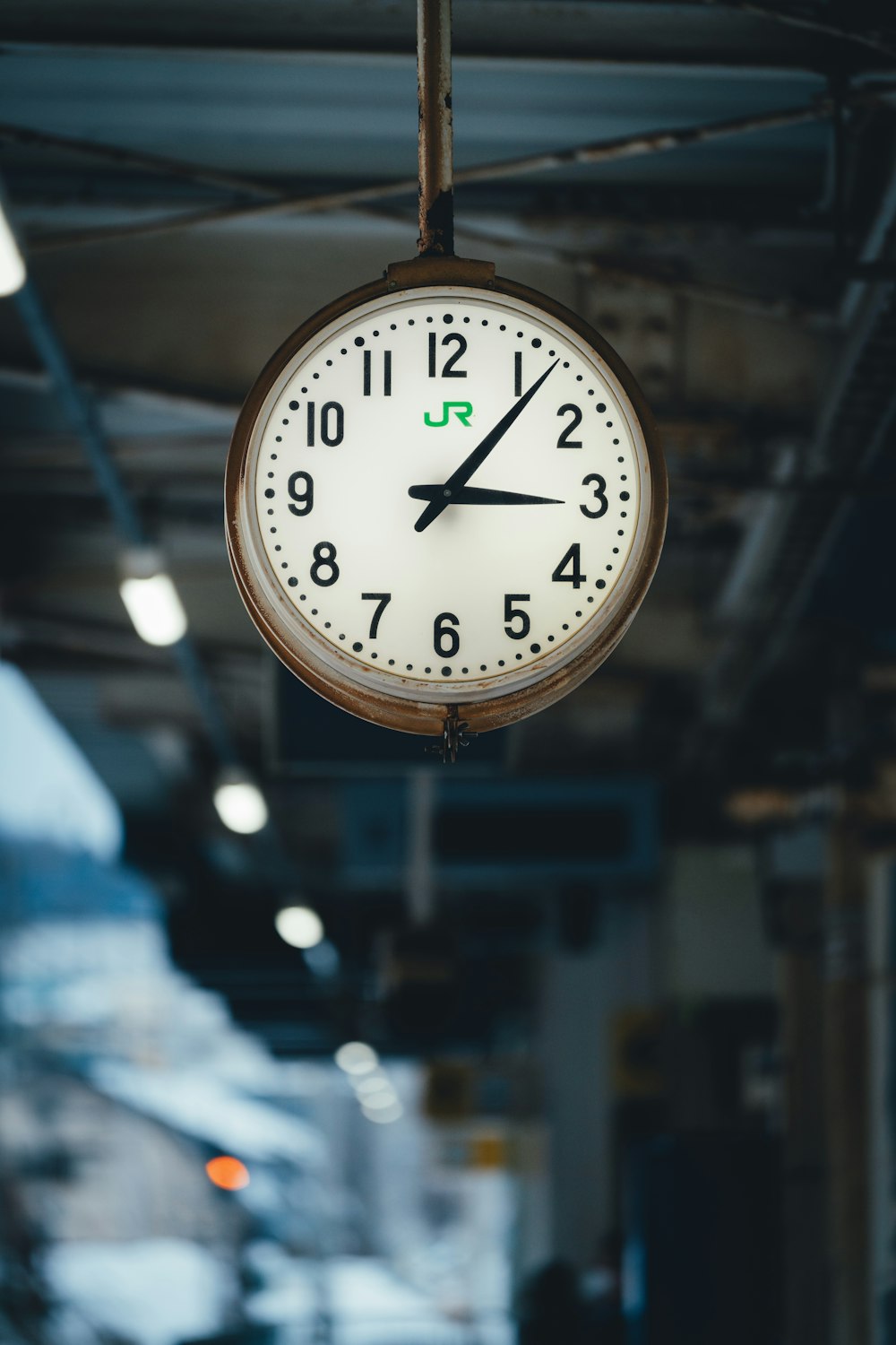 a clock hanging from the ceiling of a building