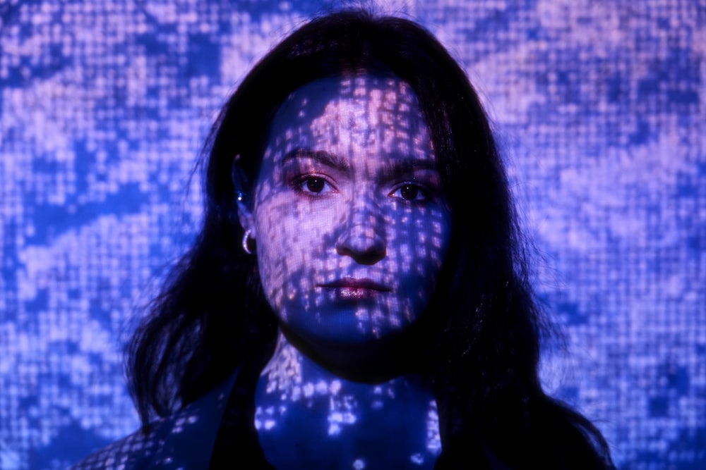 a woman in a black shirt and a blue background