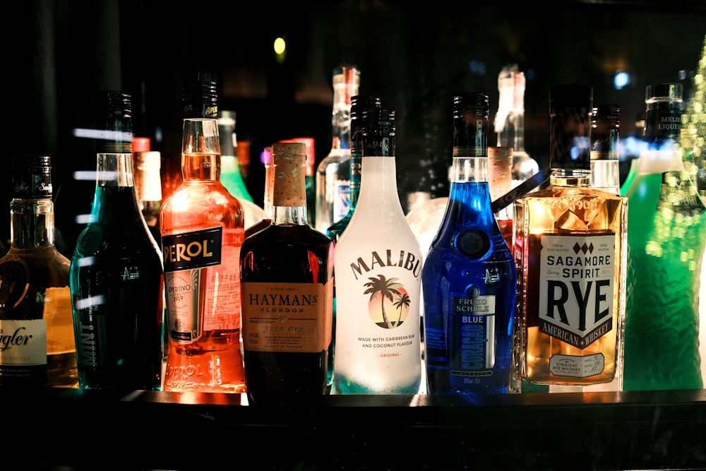 a bunch of liquor bottles lined up on a shelf