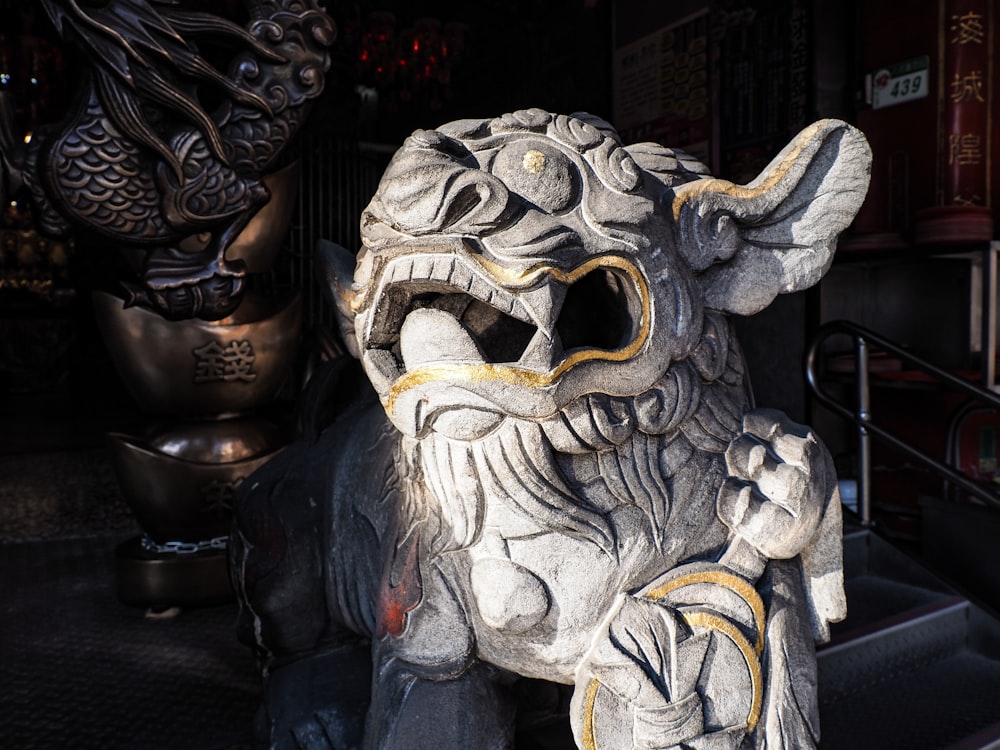 a statue of a lion with its mouth open