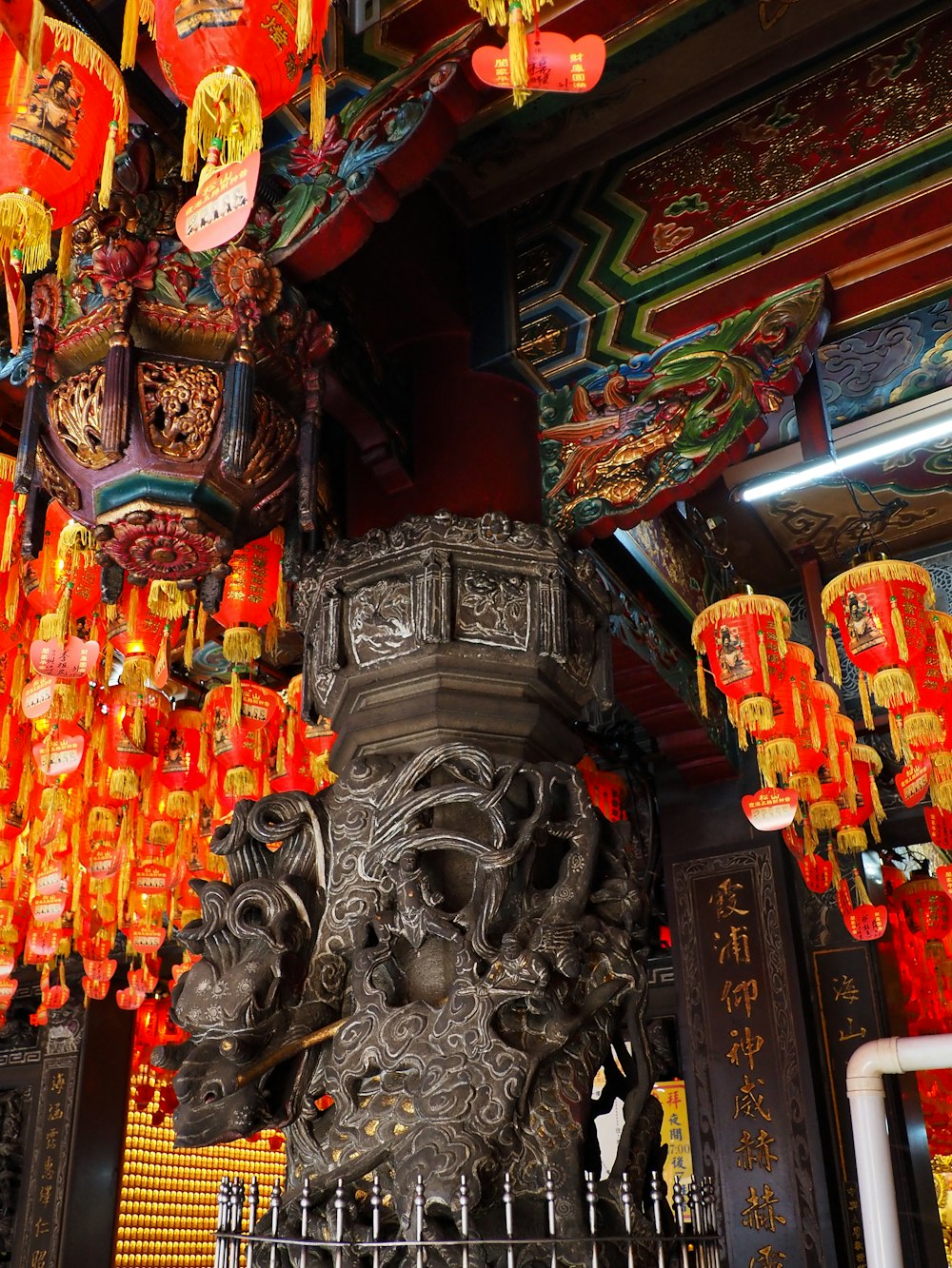 a statue of a lion surrounded by red lanterns