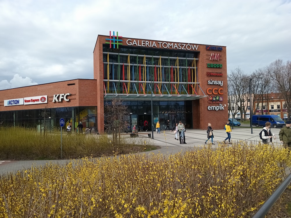 a group of people walking in front of a building