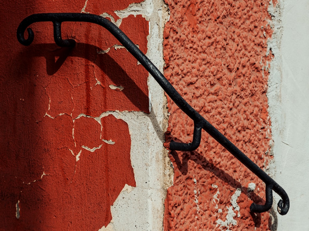 a close up of a metal handle on a red and white wall