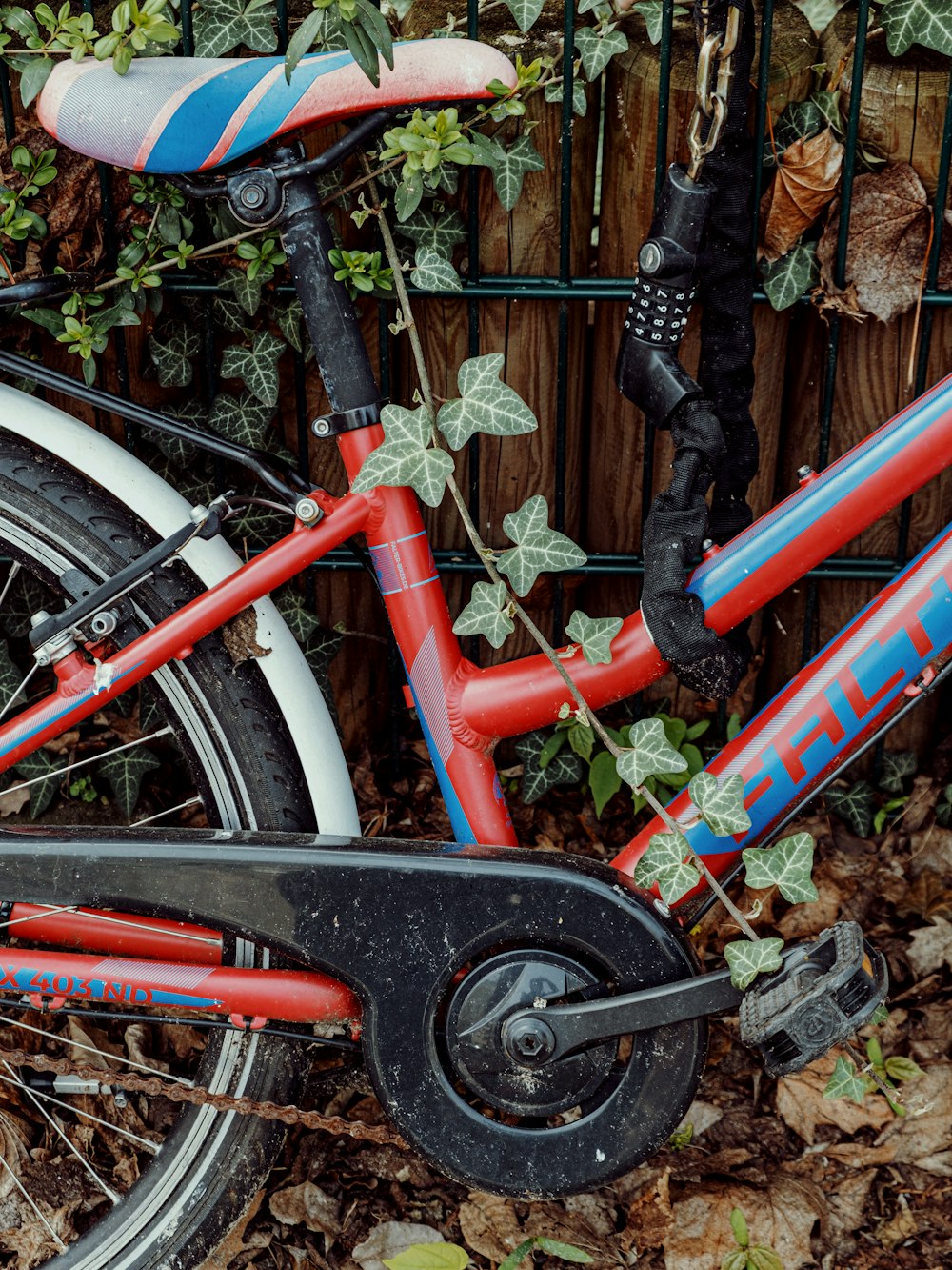 a red bicycle with a blue and red seat