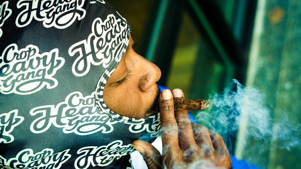 a man smoking a cigarette while wearing a bandana
