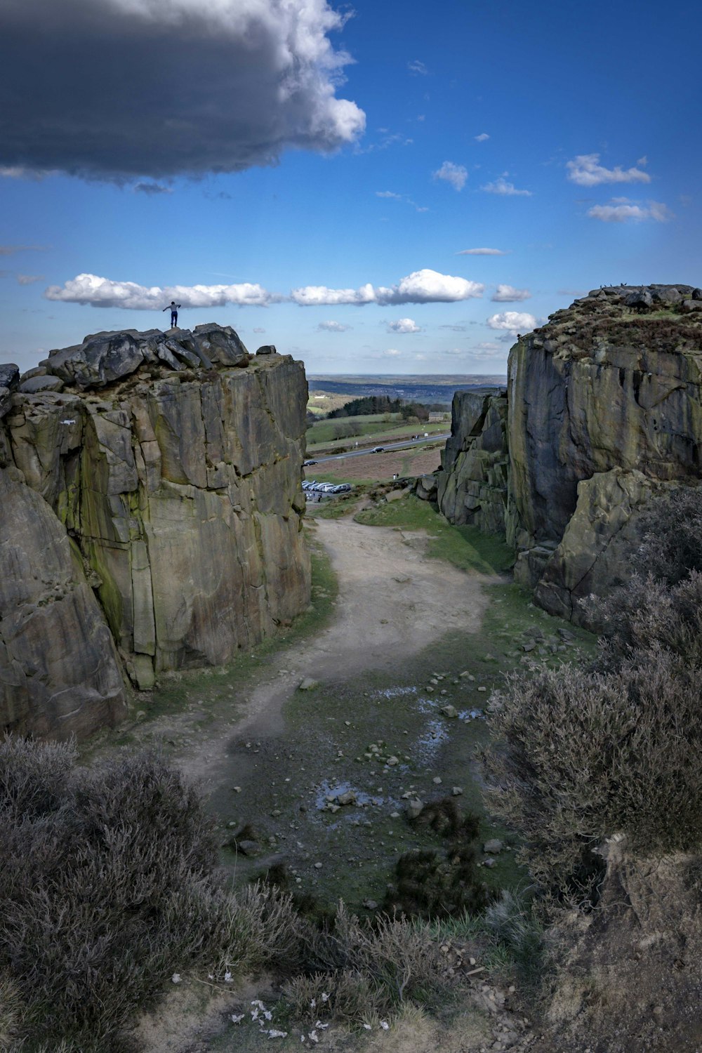 a person standing on top of a large rock formation