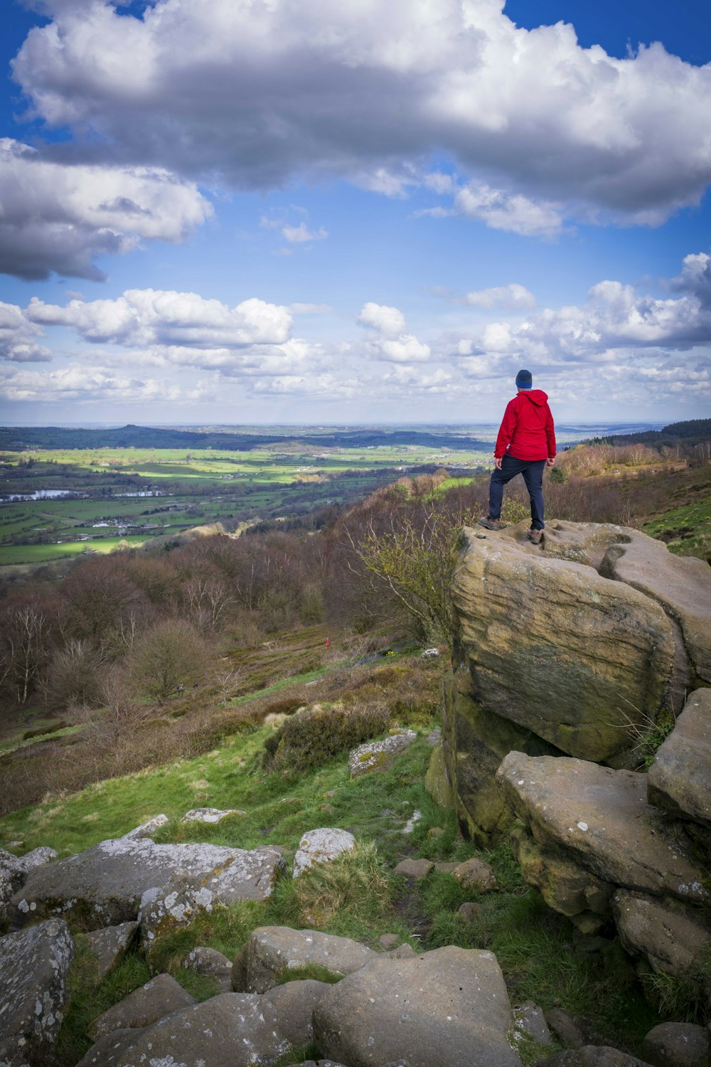 a man standing on top of a rock formation