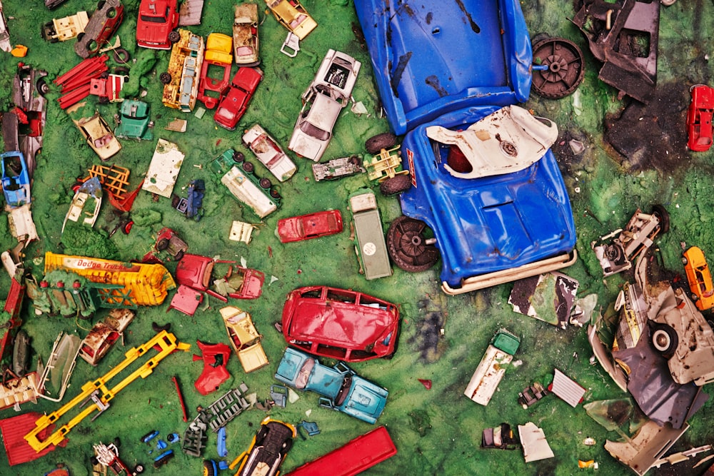 a bunch of toy cars and trucks on the ground