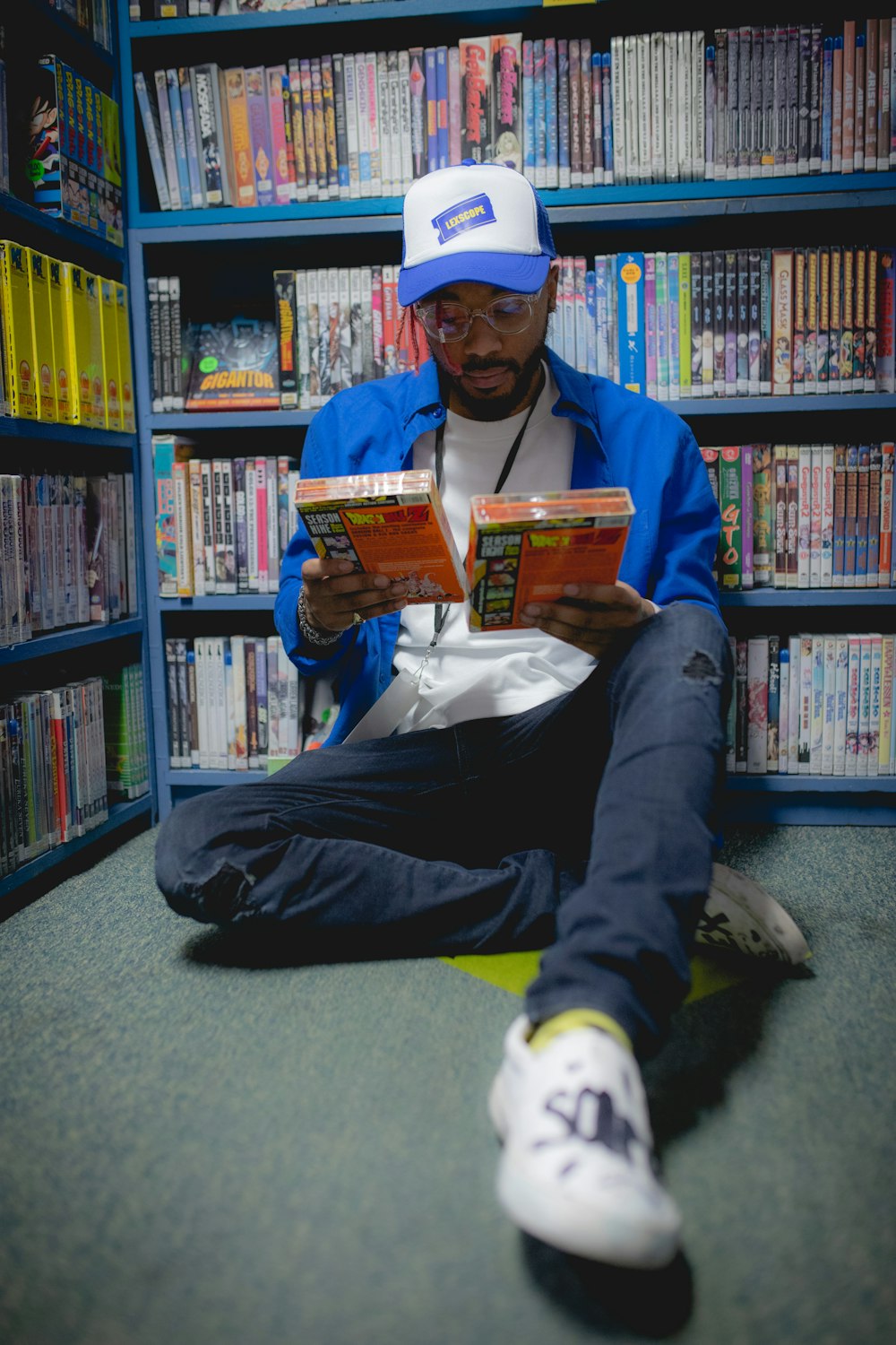 a man sitting on the floor reading a book