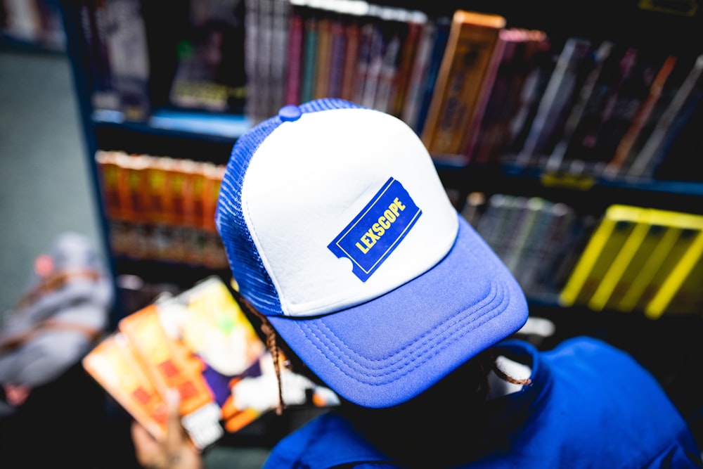 a blue and white hat sitting on top of a person's head