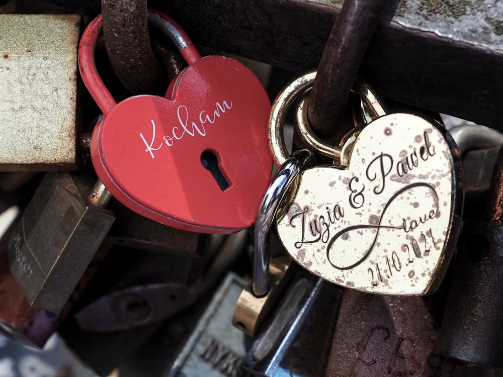 a couple of heart shaped padlocks attached to a bridge