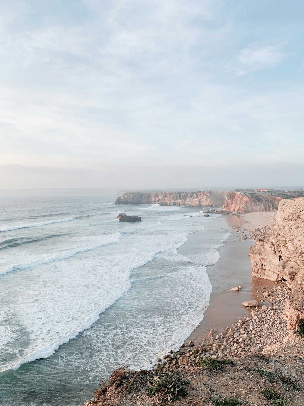 a view of the ocean from the top of a cliff