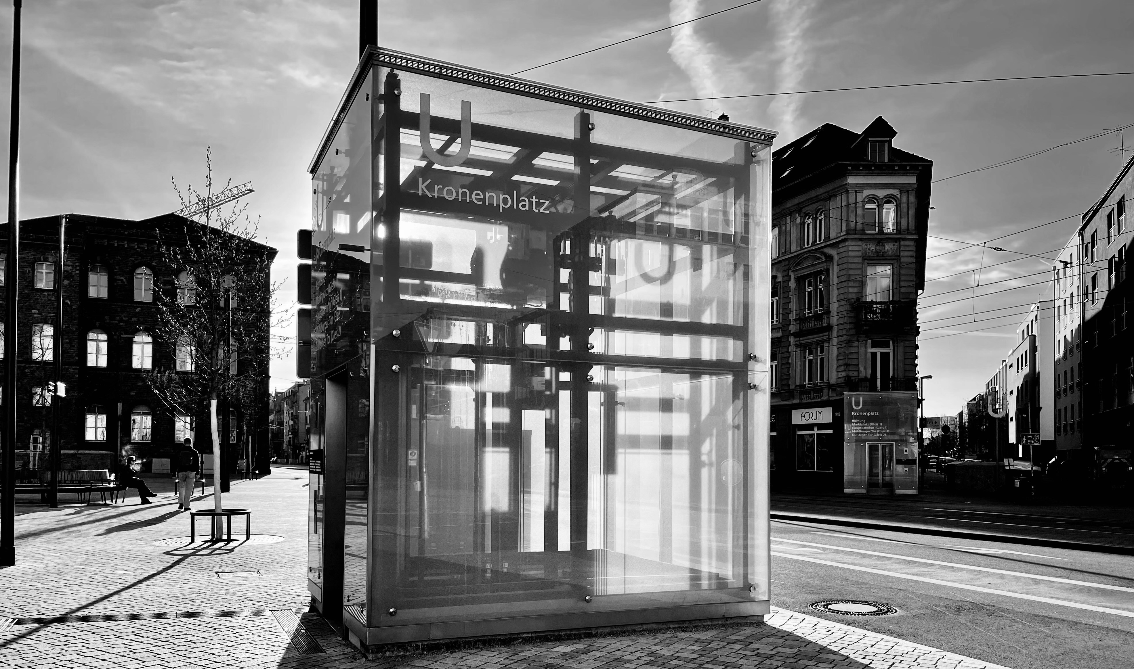 a black and white photo of a bus stop