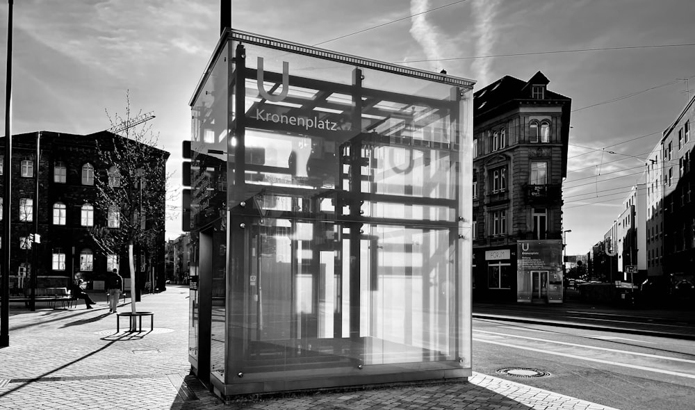 a black and white photo of a bus stop