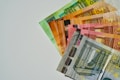 a pile of mexican currency sitting on top of each other