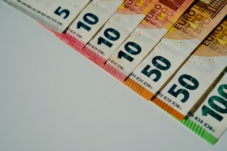 a row of ten hundred dollar bills sitting on top of a table