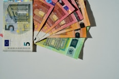 a bunch of money sitting on top of each other