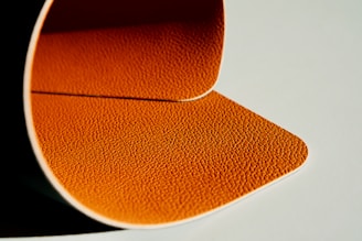 a close up of an orange object on a white surface