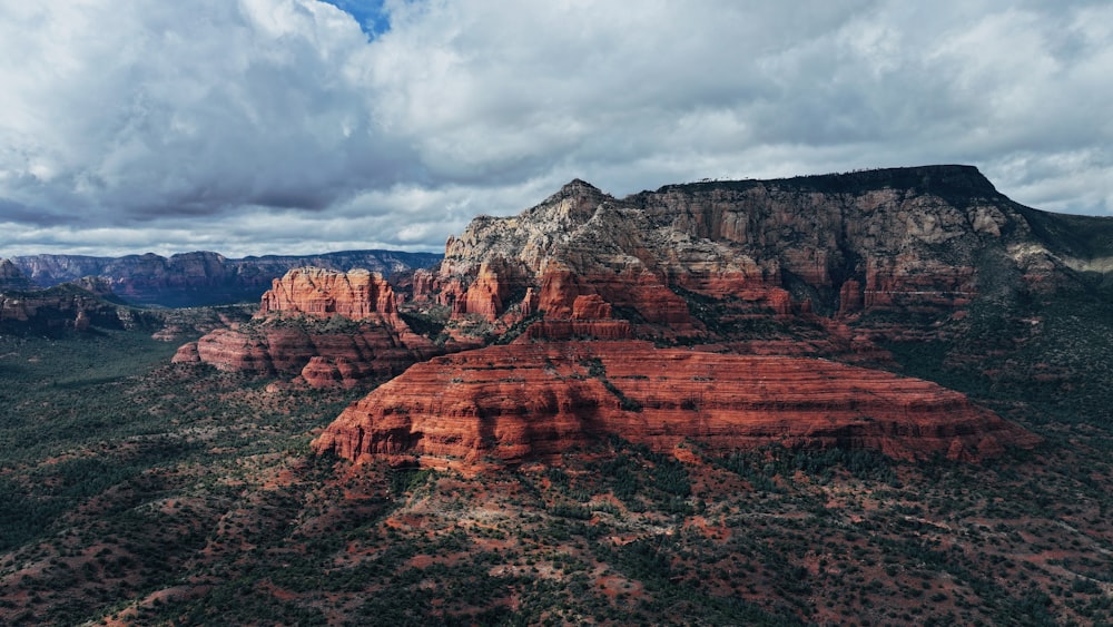 a scenic view of a mountain range with clouds in the sky