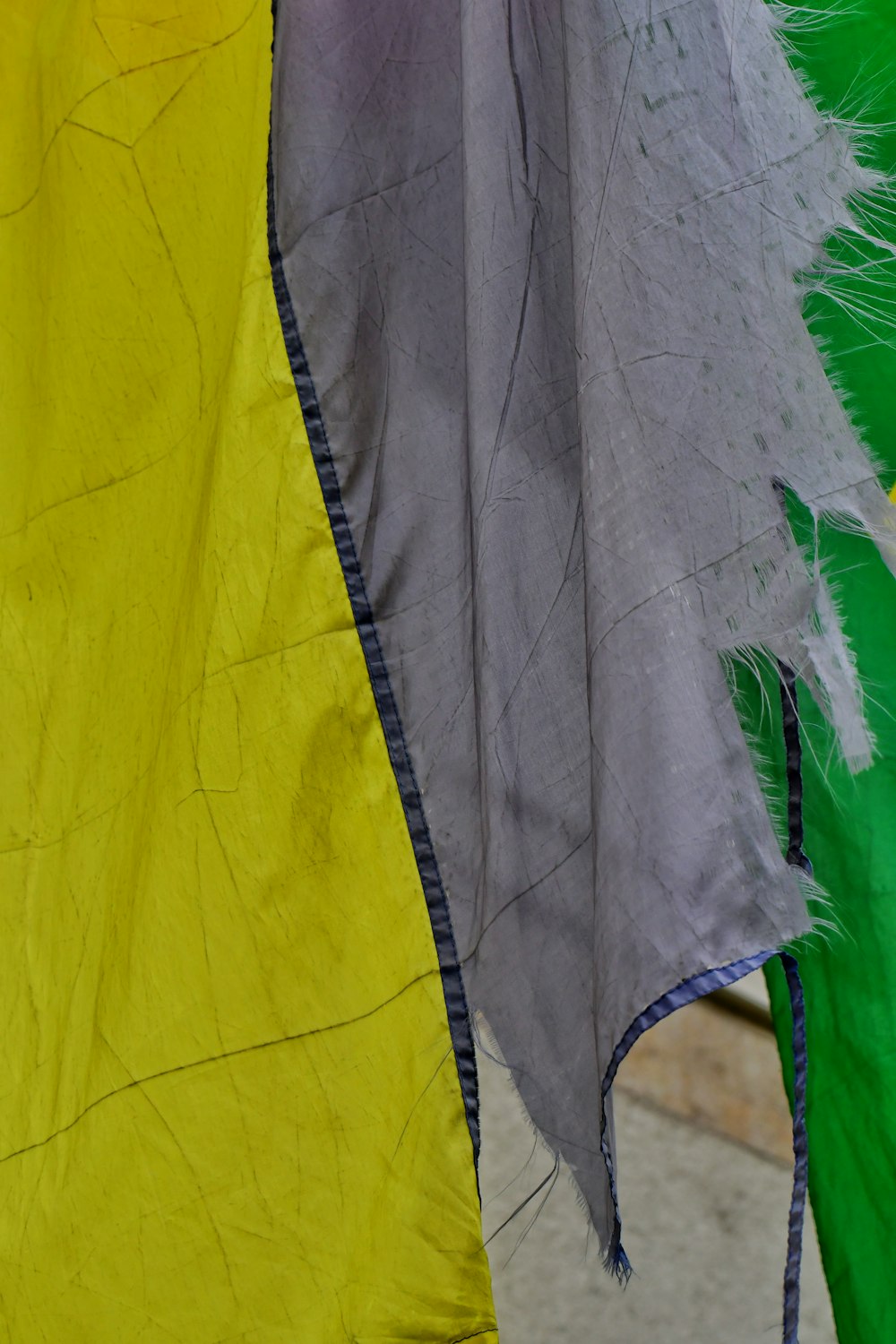 a close up of a yellow and green kite