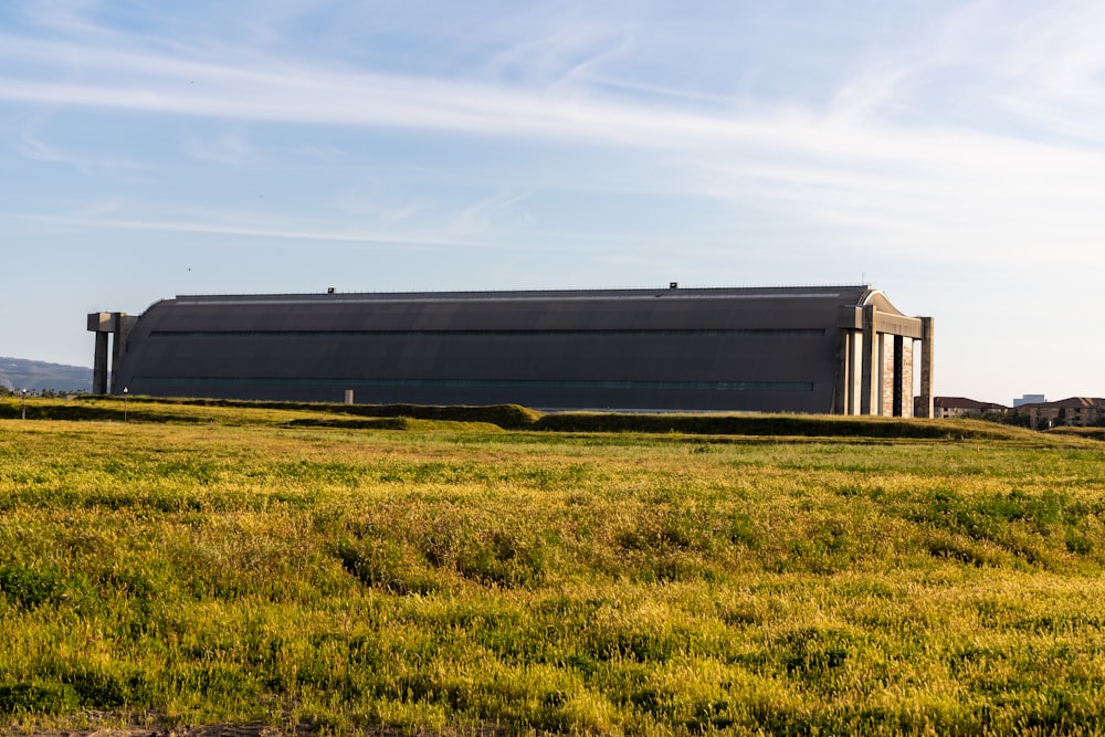 a large building sitting on top of a lush green field