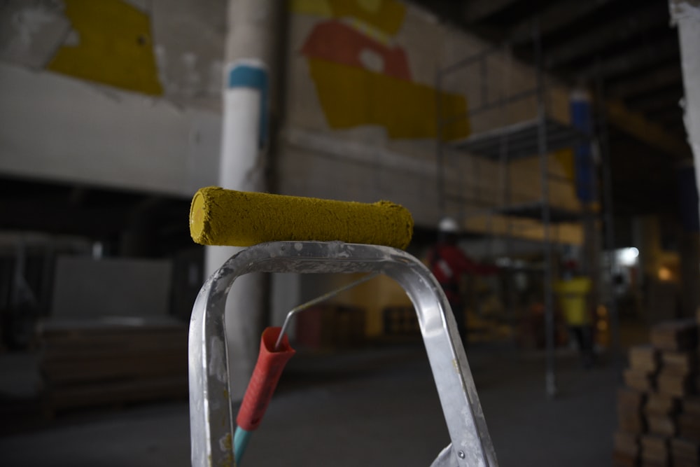 a close up of a ladder with a yellow handle