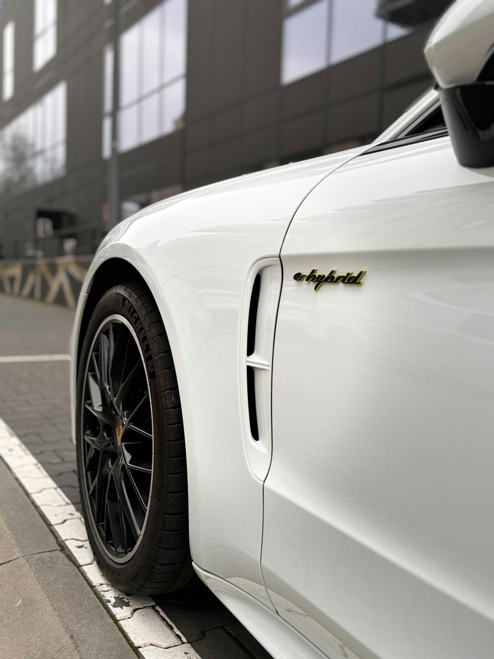 a white sports car parked on the side of the road