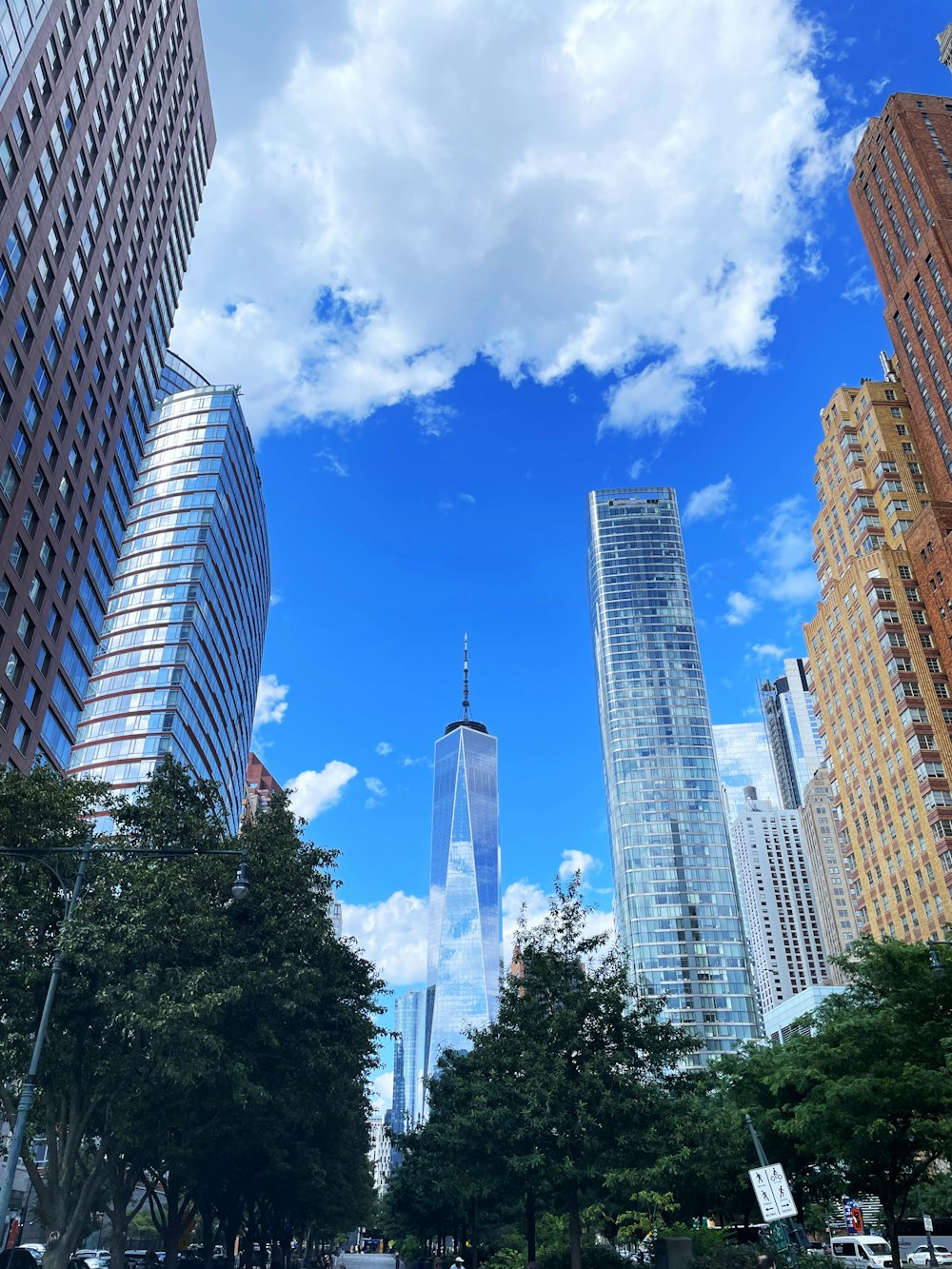 a city street with tall buildings in the background