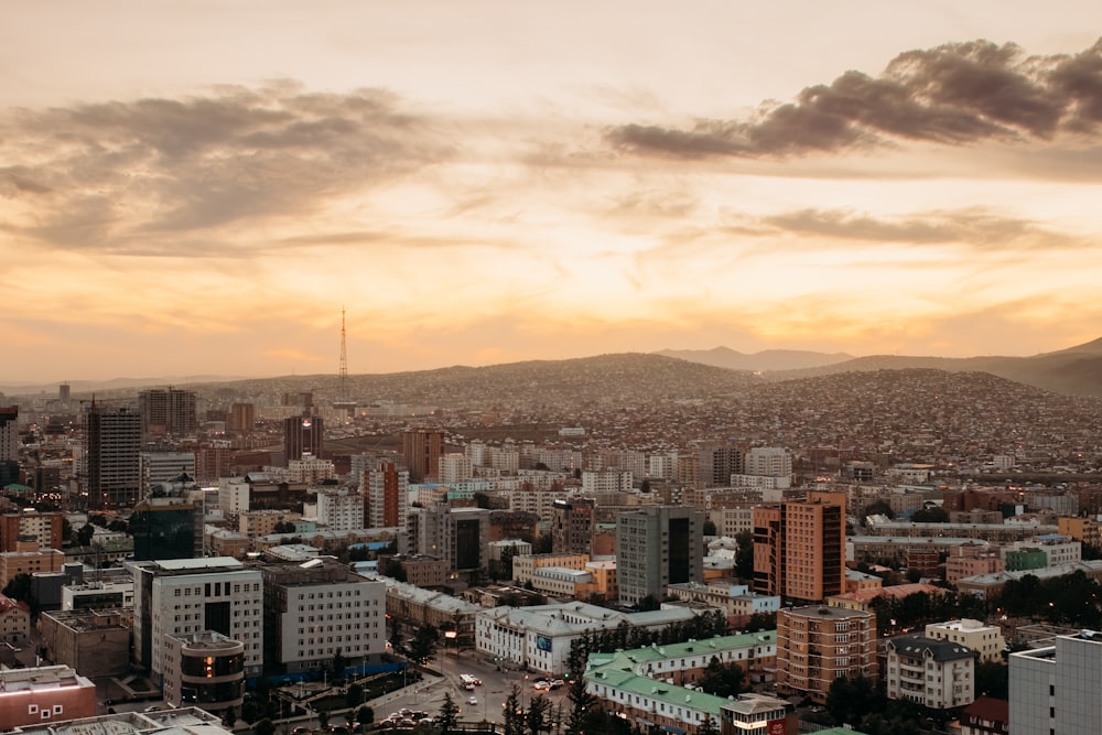 a view of a city with mountains in the background